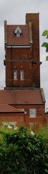 Red brick tower of at least 5 storeys