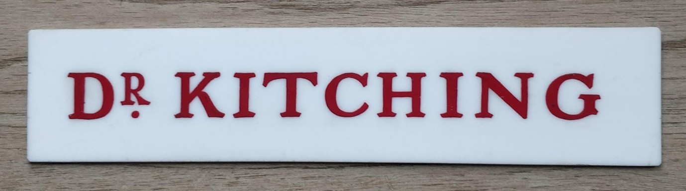 Wide white name plate reading Dr Kitching in red 