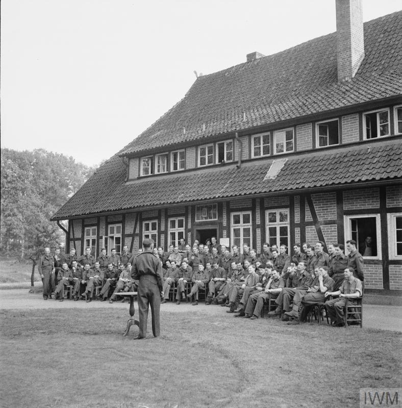 About 70 medical students at the daily conference discussing medical problems with  E M De Greff, Red Cross Relief Officer, mid-May 1945