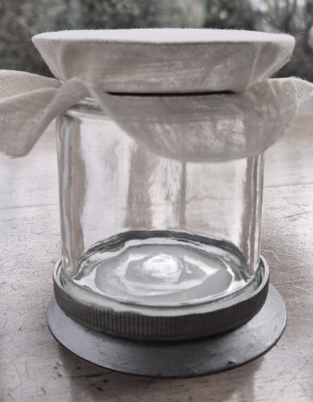 Colour photo of a jar with fabric tied over the top.