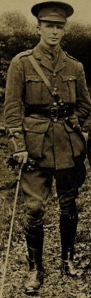 Black and photograph of William Brown from 1915. He is a tall young white man in full military uniform and a cane.