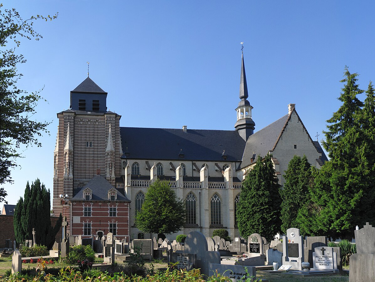 Colour photo of a very large church in a graveyard.