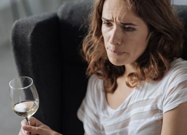 Woman holding glass of wine